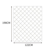 Mink weighted blanket spread out on a white bed highlighting its square stitching pattern.