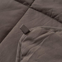 Details of the quilted stitching and fabric of a soft mink polyester weighted blanket.