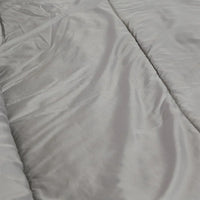 Sleeping bag rolled up and buckled for compact storage with carry handle