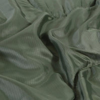 Sleeping bag folded and rolled with compression straps for easy portability.