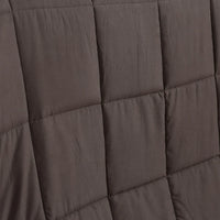 Hand pressing the plush surface of the DreamZ heavy weighted blanket showing softness.