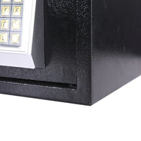 Hand entering code on electronic safe digital keypad for unlocking the safe.