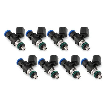 Side angle of motorsport fuel injector highlighting nozzle and electrical connector.