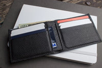 Black leather wallet opened to display six card slots and compartments.