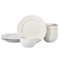 Close-up of white ceramic bowls and dinner plates with subtle geometric design in glossy finish.