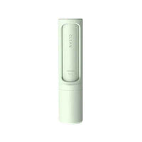 Hand pressing button on pet hair remover brush to empty collected fur from dustbin.