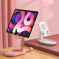 Pink desk phone holder unfolded, holding a smartphone in landscape orientation.