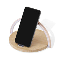 Close-up of wireless charger block holder's charging surface with a glowing USB port.