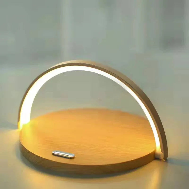 Wireless charger holder on desk with phone angled for easy charging and use.