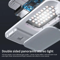 Bluetooth remote control for selfie mobile phone holder shown against dark background.