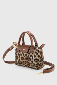 Side angle showing slim profile and strap of the black PU leather crossbody bag.