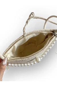 Close-up of the bag's pearl design and knitted fabric texture highlighting craftsmanship.