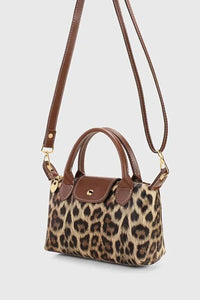 Interior view of crossbody bag showing polyester lining and inner pockets.