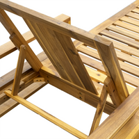 Outdoor wooden lounge chair showing smooth acacia wood finish and plush blue cushion.