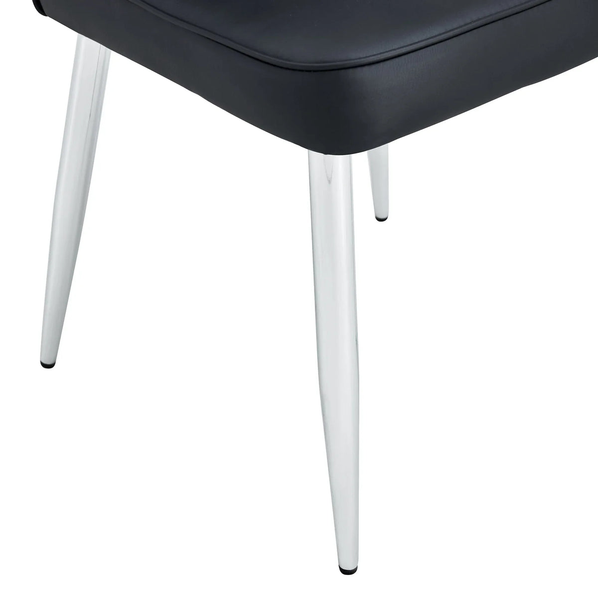 Set of black minimalist dining chairs arranged in dining room setting