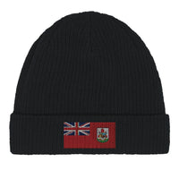 Close-up of a green cotton beanie with a Bermuda flag patch on the front
