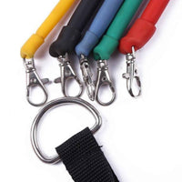 A set of colorful resistance bands with handles, ankle straps, and a door anchor laid out on a white background.