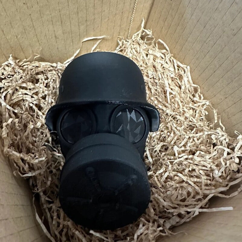 3D - printed trailer hitch cover with steel helmet and gas mask design. Protects the receiver tube from rusting.