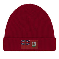 Green cotton beanie folded flat, displaying Bermuda flag emblem