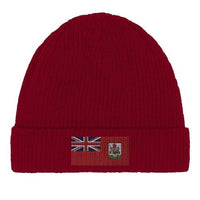 Close-up detail of the Bermuda flag emblem stitched onto green beanie