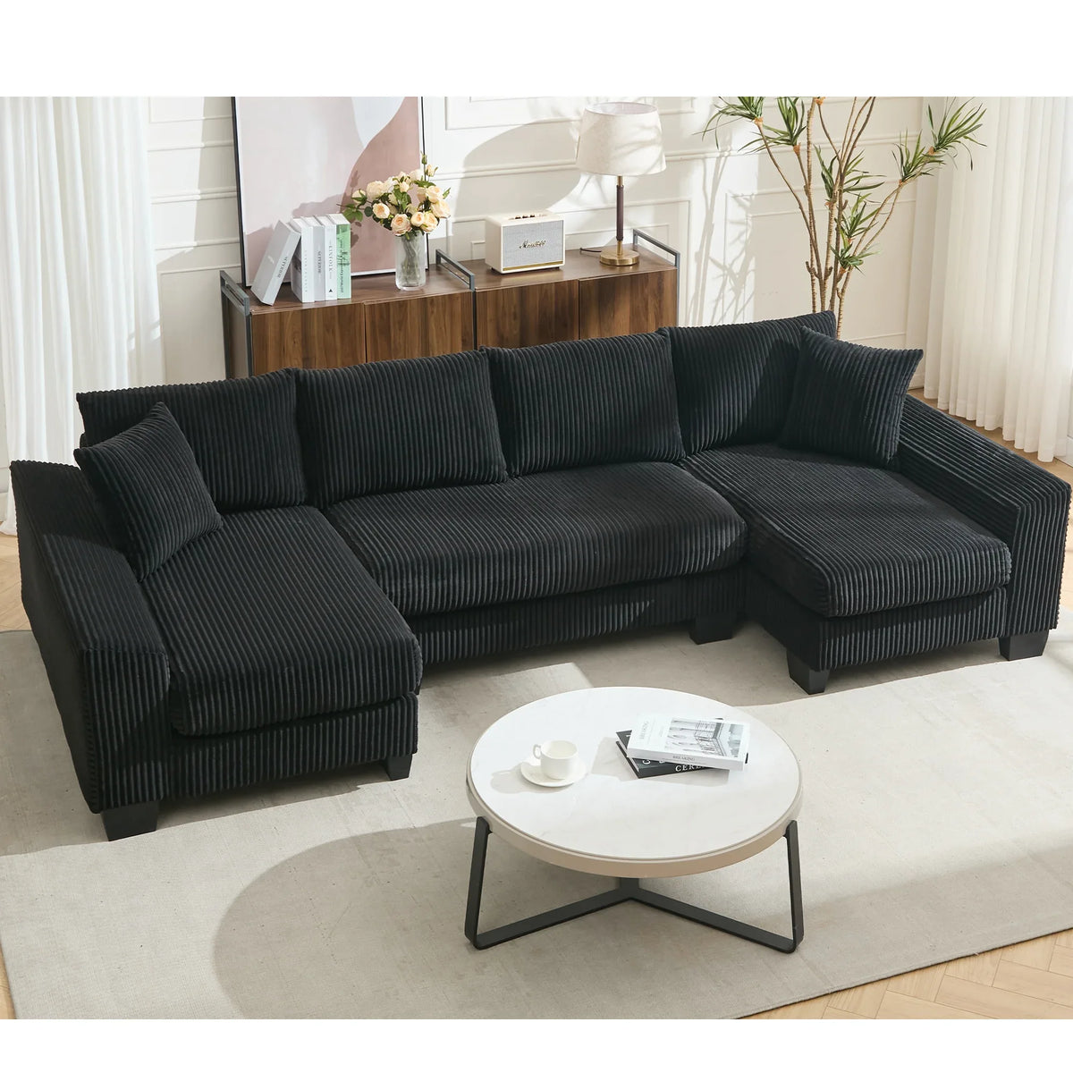 Large black U-shaped corduroy sleeper sofa with square arms, pull-out bed, and plush seating for four.