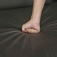 Large black modular sectional sofa with chaise lounge, upholstered in fabric, arranged in an L-shape.