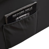 Detailed stitching and plush cushioning on the armchair's armrest and footrest