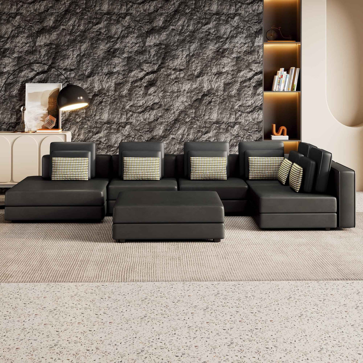Large black modular sectional sofa with chaise lounge, upholstered in soft fabric, arranged in a spacious living room.