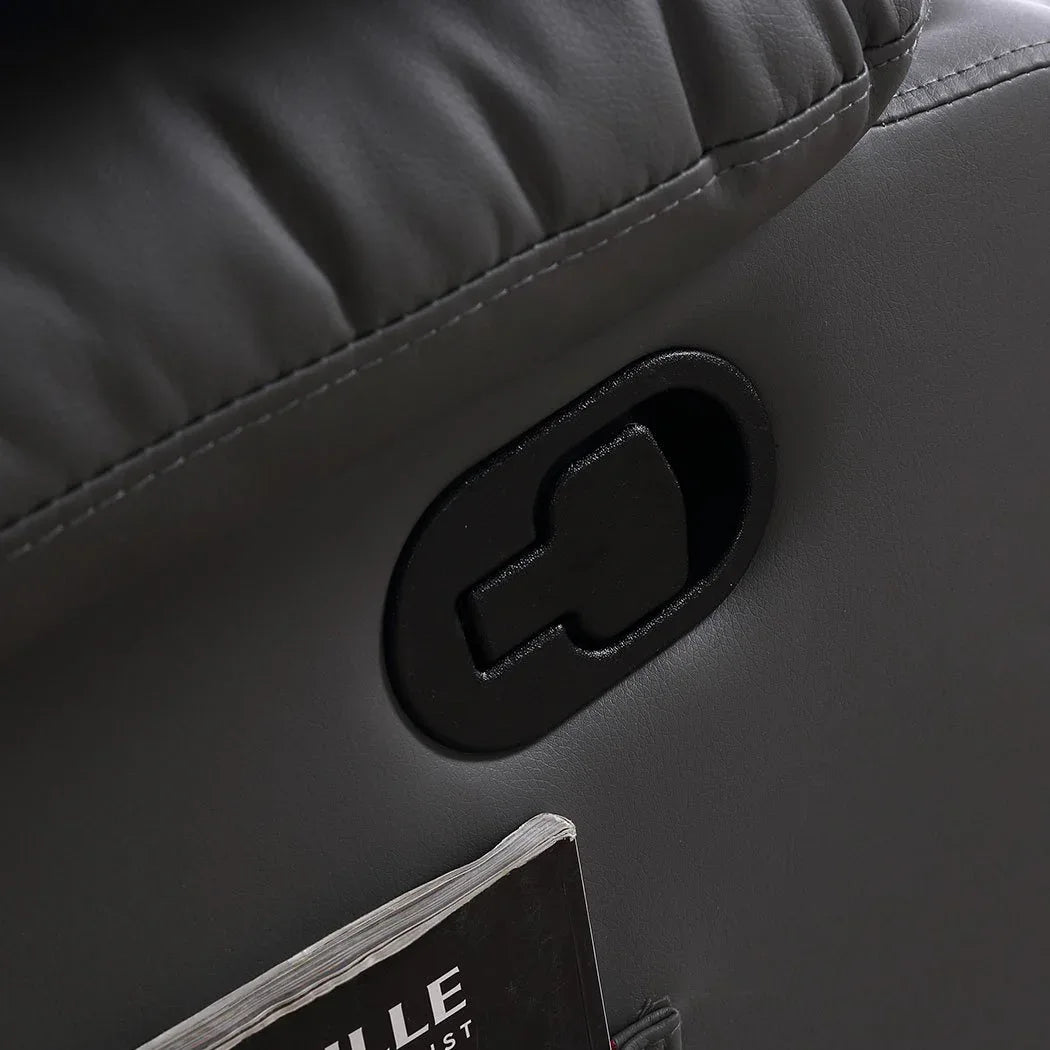 Massage chair recliner with removable tray holding drink and snacks beside a sofa