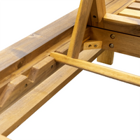Detailed view of lounge chair’s natural wood frame and cushioned seating area.