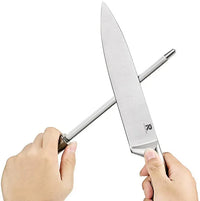 Wooden rotating knife block holding multiple stainless steel knives with wood color handles.