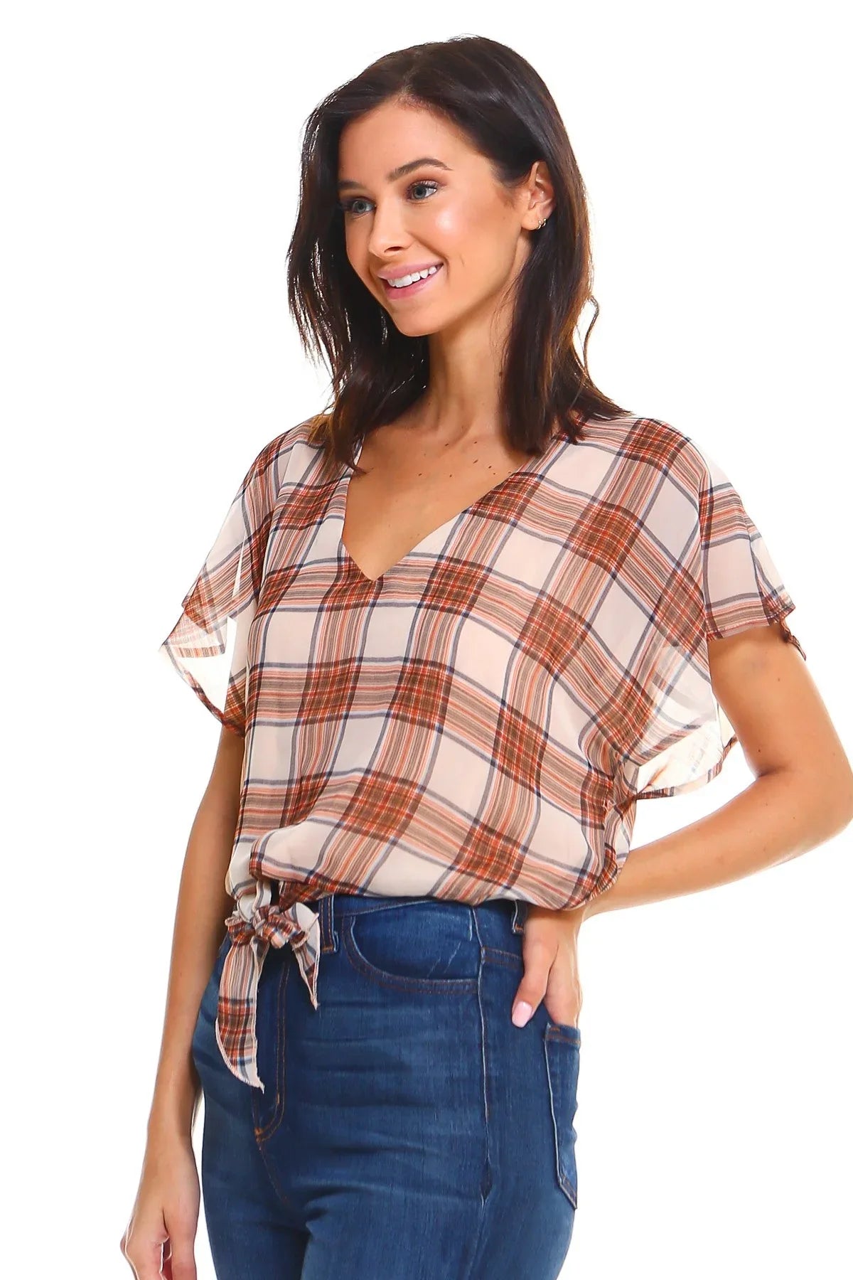 Close-up of plaid pattern and flutter sleeve detail on tie-front blouse.