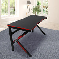 Close-up of gaming desk's smooth carbon fiber surface with subtle reflective texture.