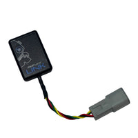 Close-up of ReFlex+ Link Control Unit showing its compact wireless module design for engine management