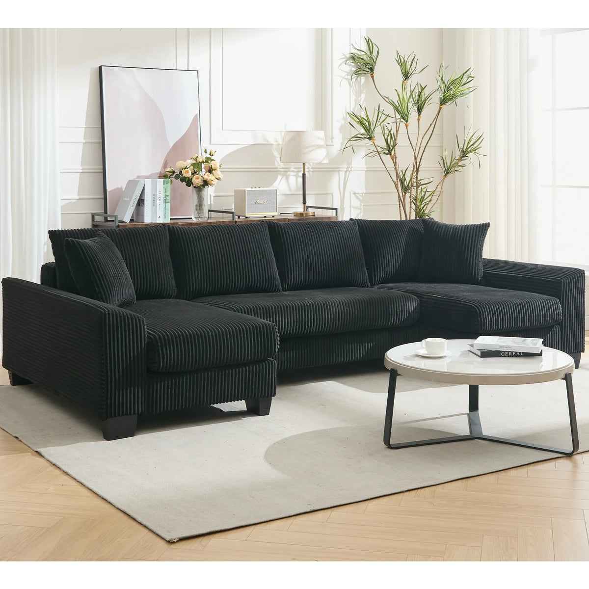 Modern black U-shaped corduroy sleeper sofa with pull-out bed and square arms, comfortably seating four people.