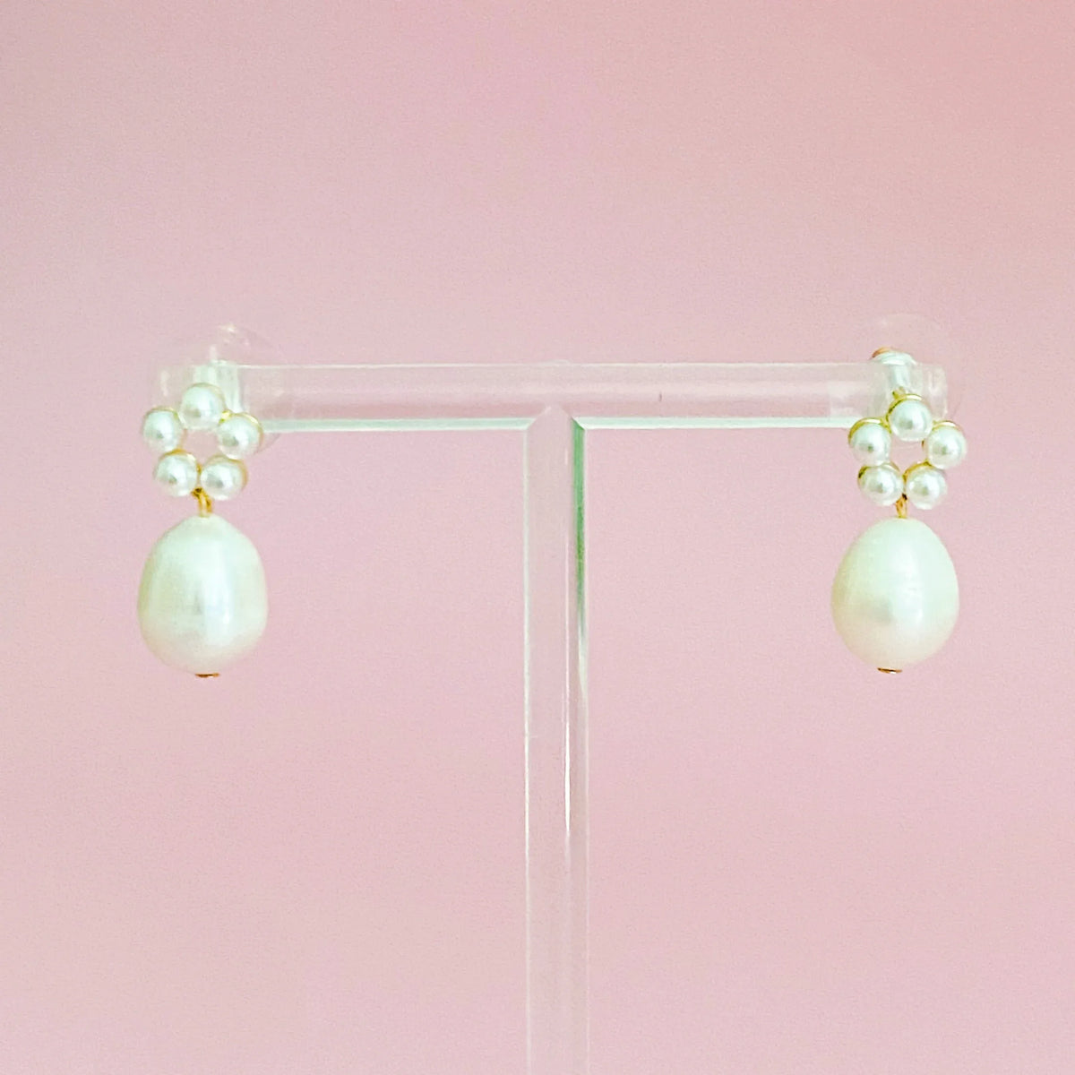 Elegant pearl drop earrings with freshwater pearl dangling, displayed on white background.