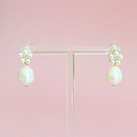 Side angle view of a Blooming Freshwater Pearl Drop Earring showcasing its elegant pearl drop and circular bead arrangement.