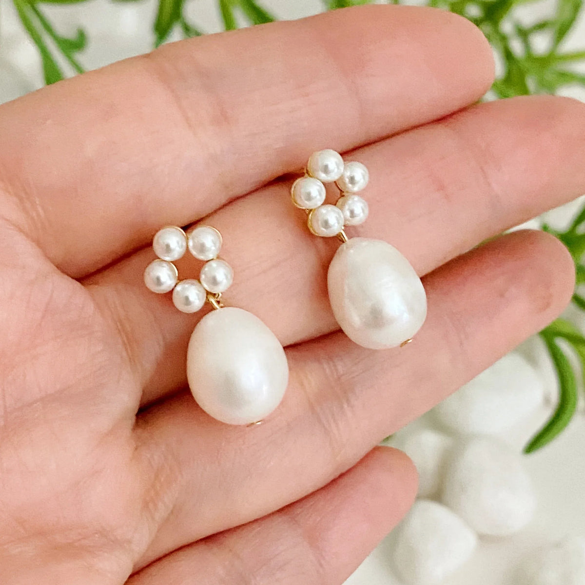 Detailed shot focusing on the pearl beads forming a circle with a freshwater pearl drop hanging below.