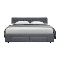 Close-up of tufted headboard with soft high-density foam padding in grey fabric upholstery.