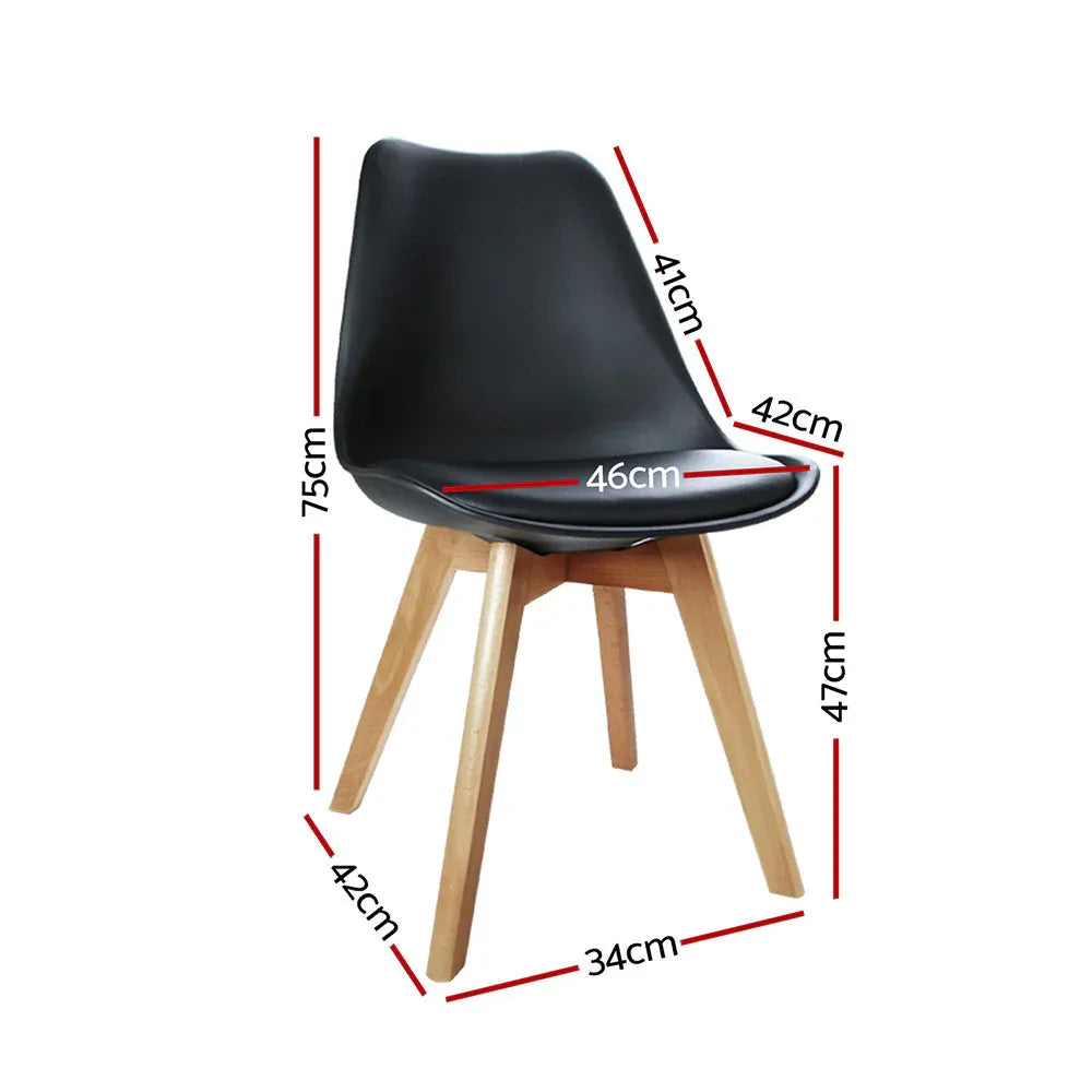 Close-up of a single black padded dining chair showing smooth PU leather and wooden legs.