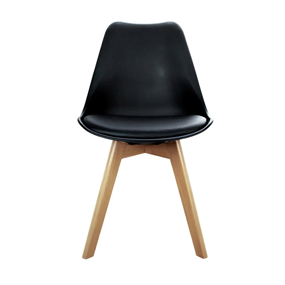 Side view of a black padded dining chair highlighting angled wooden legs and cushioned seat.