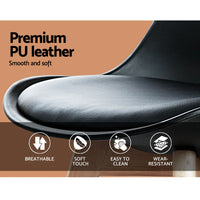 Detail of the chair’s cushioned black seat and sturdy wooden legs on a light background.