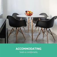 Side view of round wooden-legged dining table with clear design details