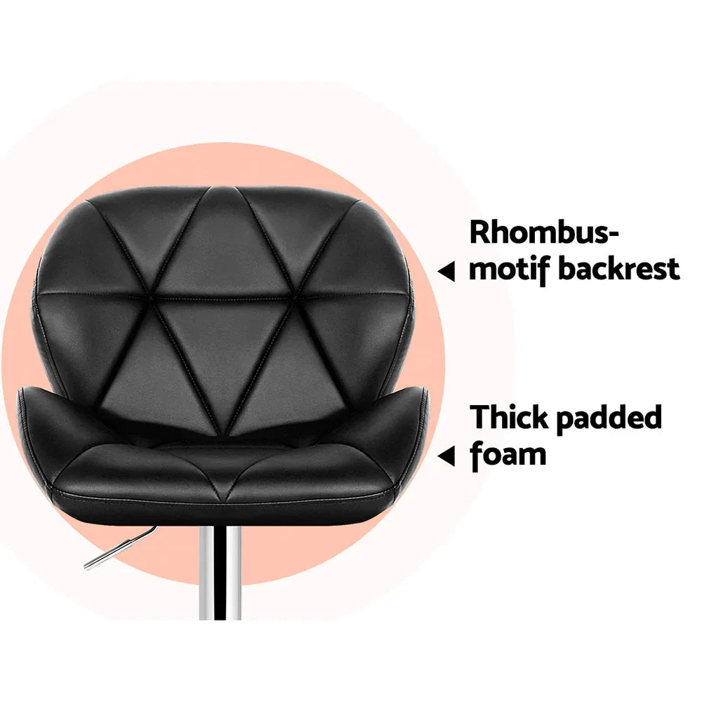 Side view of black faux leather bar stool with chrome frame and semi-circular footrest
