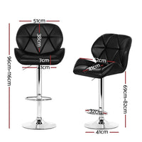Close-up of black faux leather seat on a chrome base kitchen bar stool with footrest.