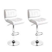 Two white PU leather bar stools with chrome bases and gas lift levers, shown in a bright setting.