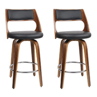 Pair of black wooden bar stools with PU leather seats and walnut-finished legs, shown from front on white background.