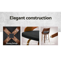Chrome steel footrest on black wooden bar stool with walnut legs, shown close-up.