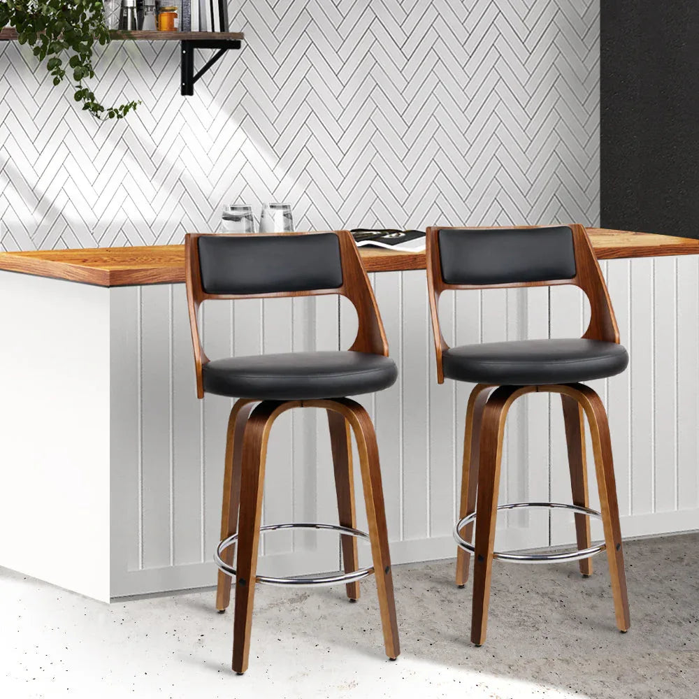 Two black wooden bar stools arranged side by side on a plain white background.