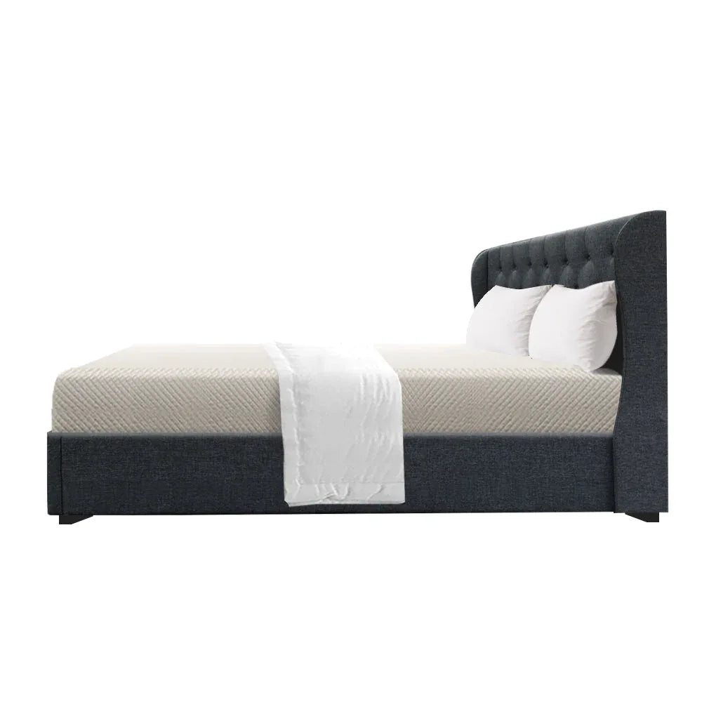 Close-up of tufted headboard with stitched details on charcoal fabric queen bed frame.